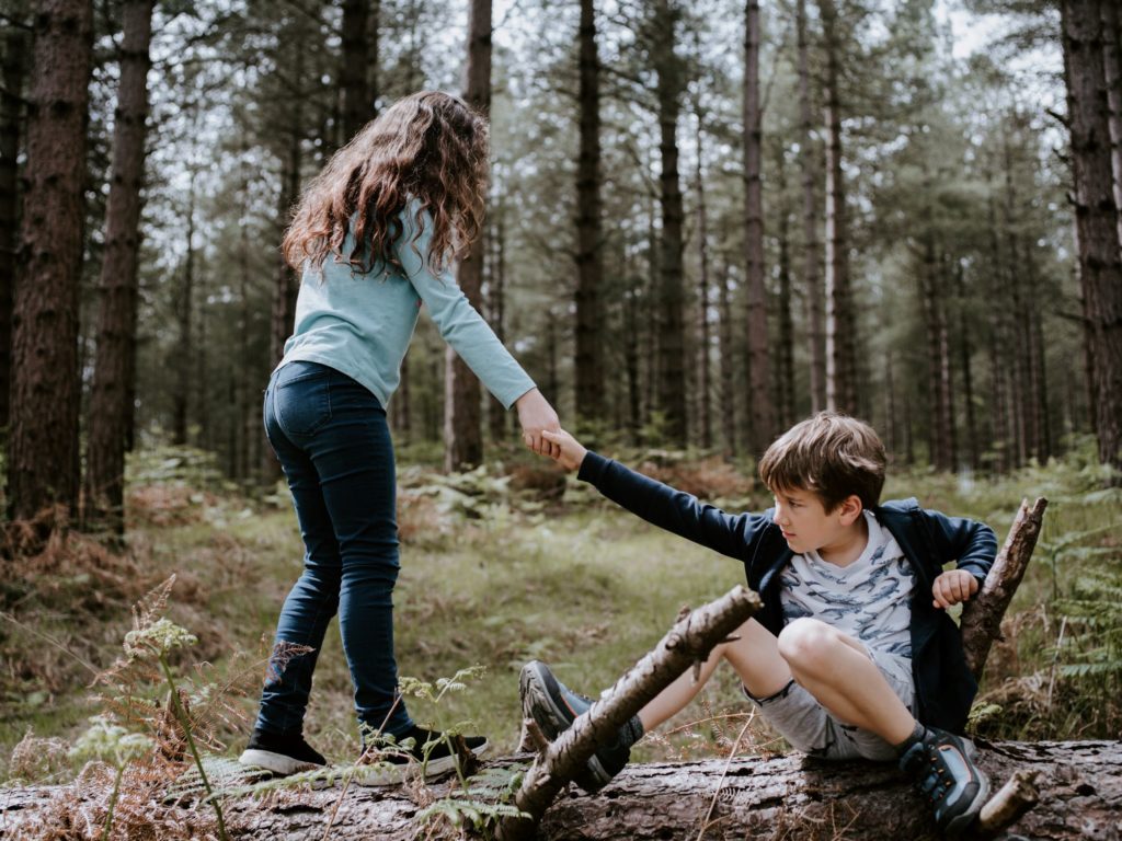 A friend helps a friend get up