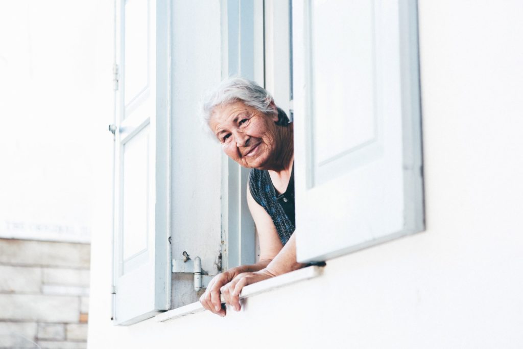 older woman looking out a window