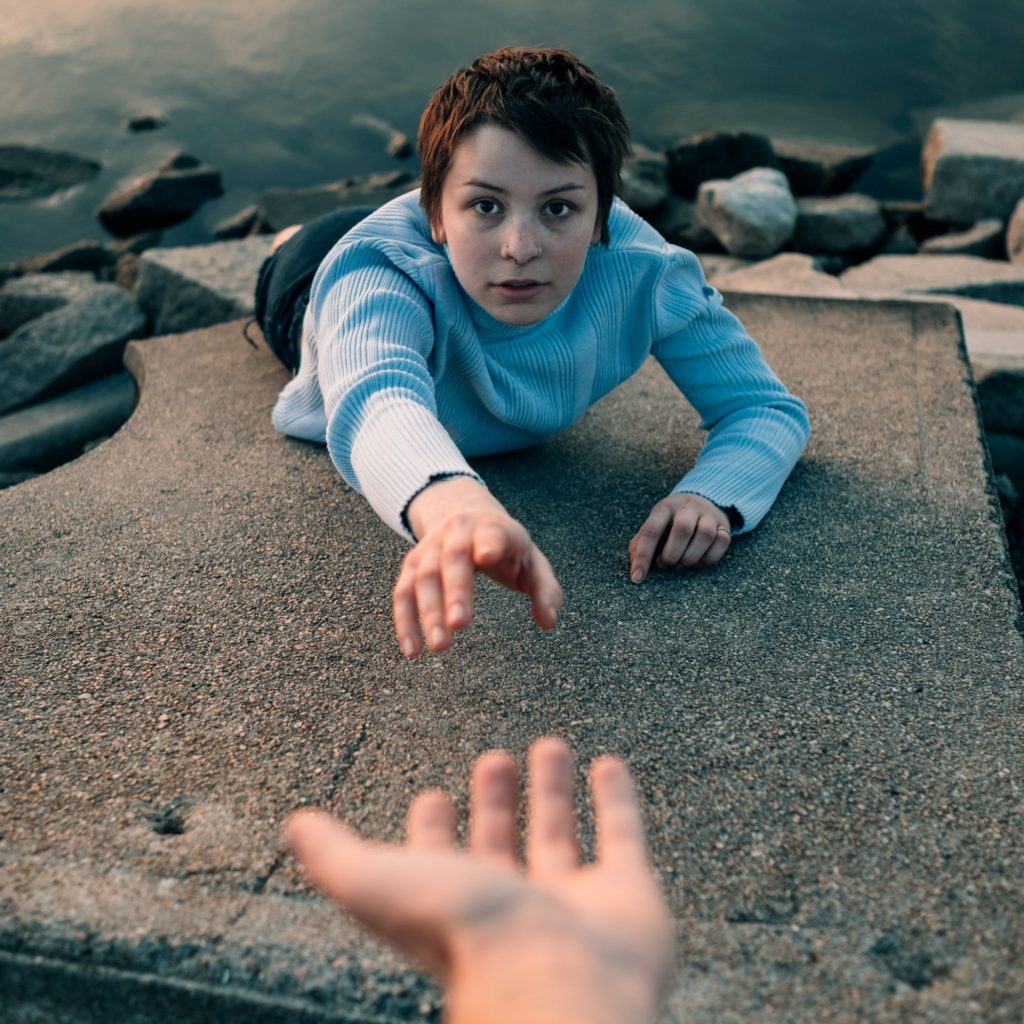 hand reaching to help friend